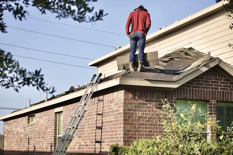 Professional roofer working on a residential roof in East View